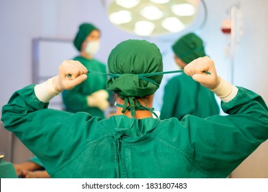 Back View Of Surgeon Doctor Wearing Protective Face Mask And Uniform In Operating Room In Hospital