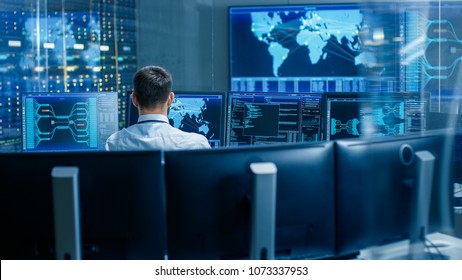 Back View in the System Control Center Operator Working. Multiple Screens Showing Technical Data. - Shutterstock ID 1073337953