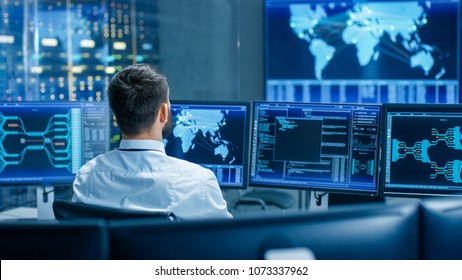 Back View in the System Control Center Operator Working. Multiple Screens Showing Technical Data. - Shutterstock ID 1073337962