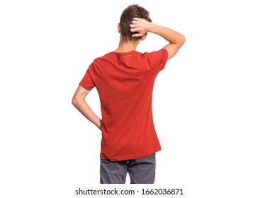 Back view. Teen boy thinking and looking to wall, isolated on white background. Thoughtful teenager in red - rear view. Confused child with his hands on head and waist.