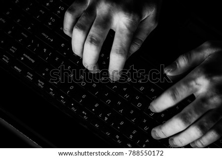 Back View of Teenage Hacker Working in Computer and Infecting with Virus Data Servers of Government Infrastructures