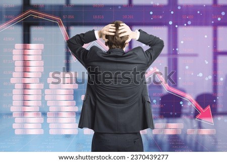 Back view of thoughtful businessman looking at creative forex chart hologram with declining stacked coins on blurry office interior background. Financial recession, plummet concept. Double exposure