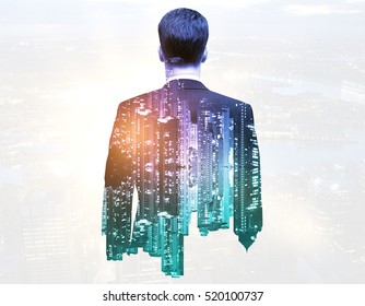 Back view of thoughtful businessman on night city background. Double exposure. Research concept - Powered by Shutterstock