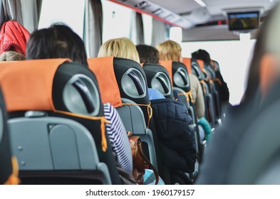 Back View Of The Tourists Travelling In The Coach Bus. Travel Concept. Selective Focus.