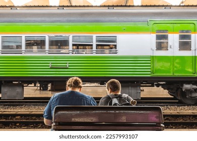 Back view of travelers waiting for the train. - Shutterstock ID 2257993107