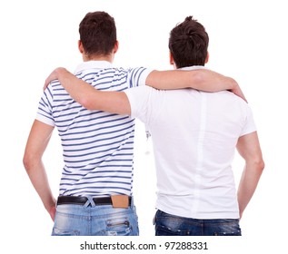 Back View Of Two Friends  Standing Embraced And Looking At Something On White Background