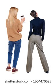 Back View Of Two Woman In Sweater. Rear View People Collection. Backside View Of Person. Isolated Over White Background. Girls Are Looking Forward