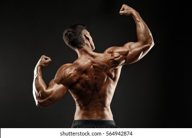 Back view of Unrecognizable man, strong muscles posing with arms up
