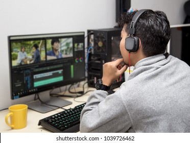 back view of video editor using computer