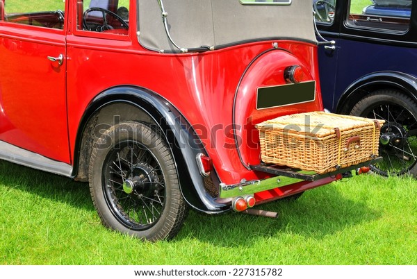 Back view of\
vintage car with picnic\
basket