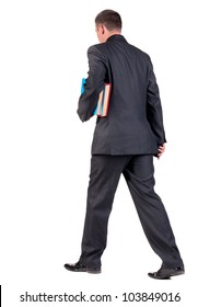 Back View Of Walking  Business Man With Books. Going Young Guy In Black Suit. Isolated Over White Background. Rear View People Collection. Backside View Of Person