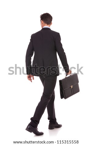 back view of a walking business man holding a briefcase and looking to his side on white background