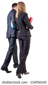 Back View Of Walking Business Team. Going Young Couple With Books. Beautiful Friendly Girl And Guy In Suit . Rear View People Collection. Backside View Of Person. Isolated Over White Background