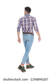 back view of walking casual man wearing jeans and plaid shirt looking to side on white background, full length picture