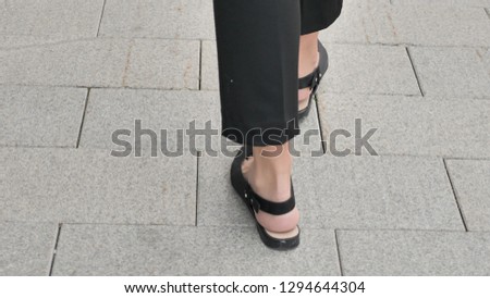 Back View of Walking Female Feet