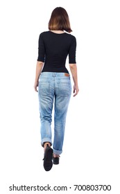 Back View Of Walking Woman. Beautiful Blonde Girl In Motion. Backside View Of Person.  Rear View People Collection. Isolated Over White Background. Girl In Jeans And A Black T-shirt Goes Into Distance