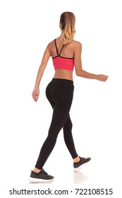 Back View Of A Walking Woman Fitness Instructor Looking To Side On White Background