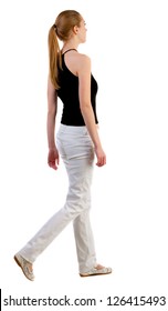 Back View Of Walking  Woman  In  White Jeans And Shirt. Beautiful Blonde Girl In Motion.  Backside View Of Person.  Rear View People Collection. Isolated Over White Background.