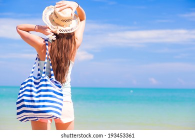 Back View Of A Woman With Bag At Beach