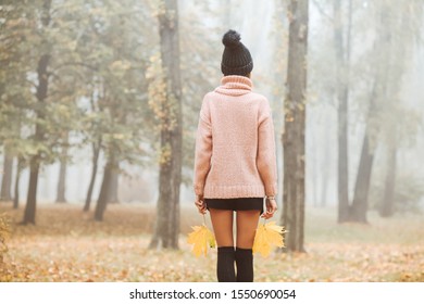 Back View Of Woman In Beanie Standing In Autumn Park