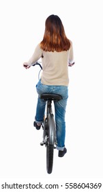 Back View Of A Woman With A Bicycle. Cyclist Sits On The Bike. Rear View People Collection.  Backside View Of Person. Isolated Over White Background. Brunette On The Bike Slowly Going Forward.