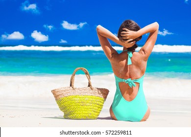 Back View Of A Woman In Bikini With Beach Bag