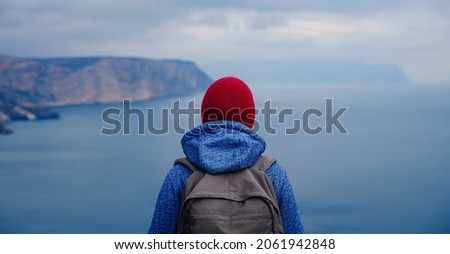 Similar – Image, Stock Photo Enjoy the view. Woman with headband, jacket. Ireland