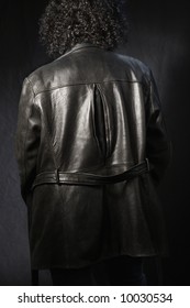 Back View Of Woman With Curly Hair Wearing Black Leather Jacket.