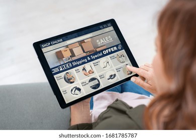 Back View Of Woman Doing Shopping Online On Website With Digital Tablet At Home. Top View Of Lady On Relaxing Sofa. Rear View Of Girl Hand Touching Screen While Selecting Product On E-commerce Portal.