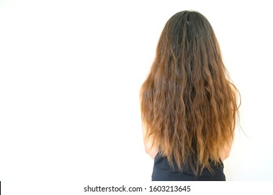Back view of woman with her damaged split ended hair. Hair damage is risk for further damage and breakage. It may also look dull or frizzy and be difficult to manage. - Shutterstock ID 1603213645