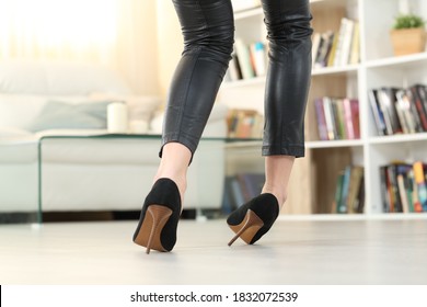 Back view of a Woman legs with high heels walking and sprain ankle