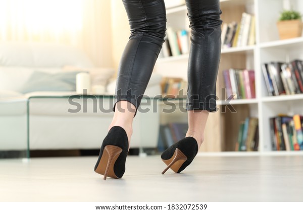 Back view of a Woman legs with high heels walking\
and sprain ankle