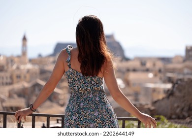 Back View Of Woman And Looking At Corfu Town In Greece. City Break, Conceptual Image.