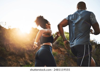 Back view, woman and man running on mountain for fitness, exercise and together for wellness. Sunshine, couple and happy in nature for health, support and performance for marathon training in morning - Powered by Shutterstock