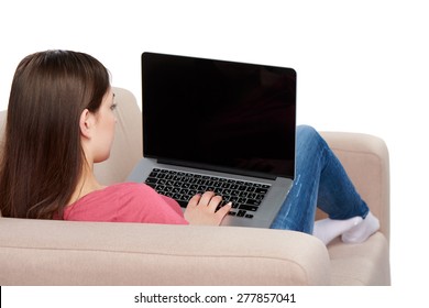 Back View Of Woman On Sofa Using Laptop, Black Screen For Your Text