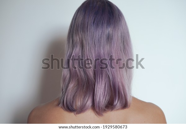 A back view of a woman with purple hair on\
white background