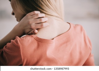 Back View Of Woman Scratching Neck While Having Allergy 