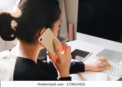 Back View Of Woman Talking Phone At Home Office