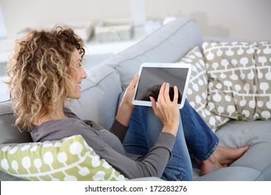 Back View Of Woman Using Digital Tablet