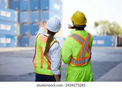 back view workers looking and pointing above in containers warehouse storage - Powered by Shutterstock