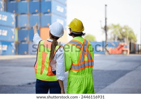 back view workers looking and pointing above in containers warehouse storage
