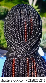 Back View Of Wrapped Black Individual Braids With Red Highlights.