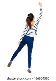 back view of writing beautiful woman. Rear view people collection.  backside view of person. Isolated over white background. Girl in a striped sweater standing on tiptoes and draws marker.