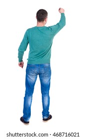 Back View Of Writing Business Man. Rear View People Collection.  Backside View Of Person. Isolated Over White Background. A Man In A Green Jacket And Jeans Marker Writing On The Wall.