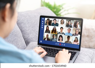 Back View Of Young Asian Business Woman Work Remotely At Home Video Conference Remote Call To Corporate Group. Meeting Online,videocall, Group Discuss Online Concept With Screen Of Teamwork On Laptop.