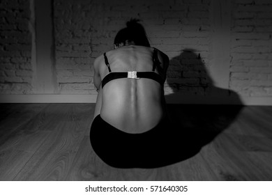 Back View Of Young Beautiful Latin Woman Or Teen Girl Sitting Sad And Alone In Edgy Darkness Feeling Depressed And Desperate In Mental And Nutrition Disorder Concept Anorexia And Bulimia