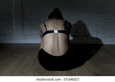 Back View Of Young Beautiful Latin Woman Or Teen Girl Sitting Sad And Alone In Edgy Darkness Feeling Depressed And Desperate In Mental And Nutrition Disorder Concept Anorexia And Bulimia