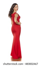 Back View Of Young Beautiful Woman Posing In A Long Red Dress On A White Background