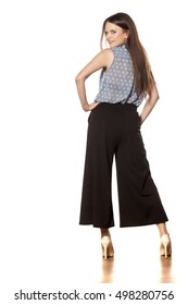 Back View Of A Young Beautiful Woman With Baggy Trousers