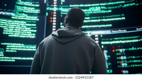 Back View of Young Black Man Looking at Big Digital Screens Glitching While Displaying Code Prompts. Worried Professional Programmer Fixing a Bug, Dealing with Crashing System, Ensuring Cybersecurity